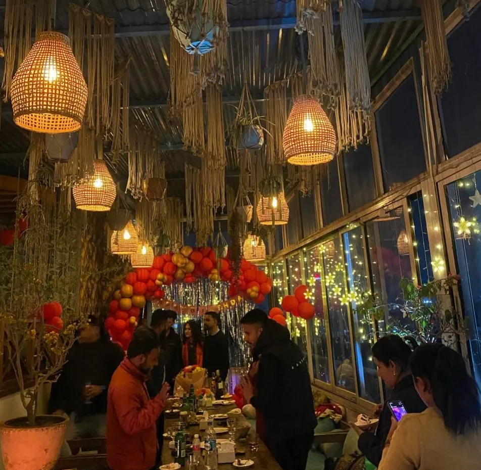 A lively evening event under hanging lanterns and red balloons at Copacabana
